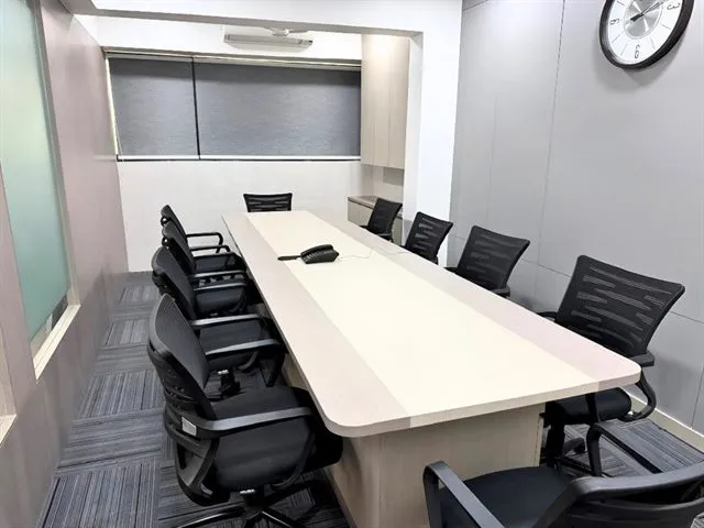 The conference room at Wisdom Cowork, seating ten around a boardroom table
