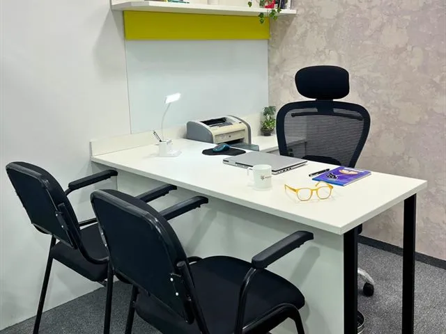 A smart private cabin at Wisdom Cowork, with a desk, printer and visitor chairs